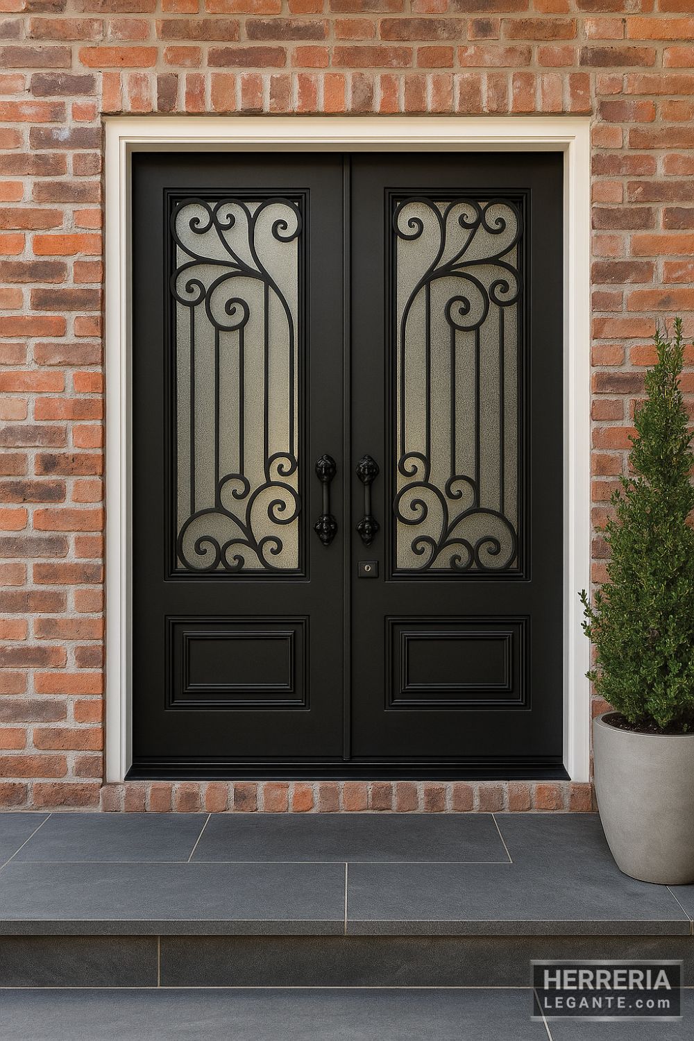 puerta de herrería doble negra con vidrio esmerilado y diseño de forja curvilínea, en fachada de ladrillo visto y planta en maceta