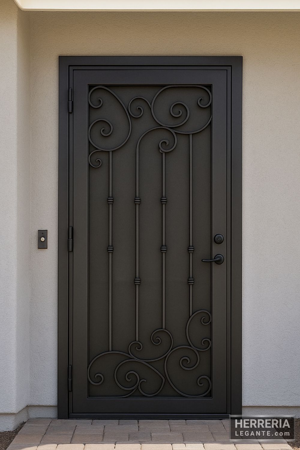 Puerta de herrería económica y liviana con barras verticales y detalles curvos, instalada en entrada principal de casa pequeña con fachada clara